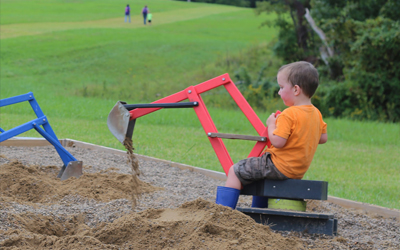 Child Playing In Sand Box